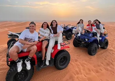a group of women riding on atvs in the desert at Merzouga nights camp& excursions in Merzouga