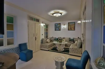 a living room with a couch and a table at Dar Chaima Apartment in Fès
