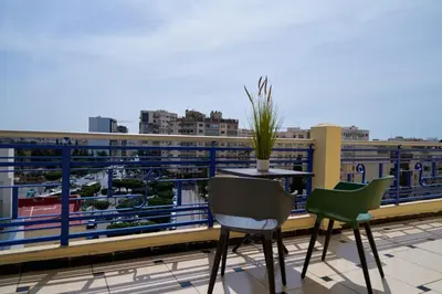 a balcony with a table and chairs and a view at Hotel Bab Mansour in Meknès