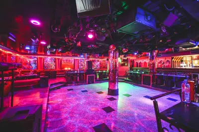 a room with a nightclub with purple lights and a bar at Hotel Bab Mansour in Meknès