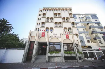 a tall white building with stairs in front of it at Hotel Bab Mansour in Meknès