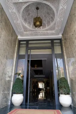 a lobby of a building with a ceiling at Hotel Bab Mansour in Meknès
