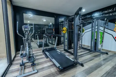 a gym with several treadmills and a treadmill at Villa d'exception spa, sport & piscine in Najem