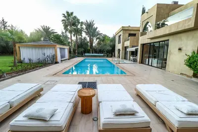 a backyard with a swimming pool and a house at Villa d'exception spa, sport & piscine in Najem