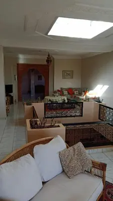 a living room with a couch and a living room with a ceiling at John's Place in Had Abdallah Rhiat
