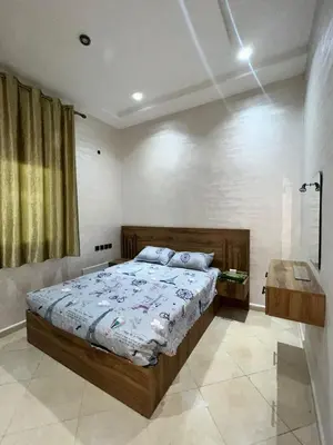 a bedroom with a large bed and a window at la ferme zine in Ain Cheggag