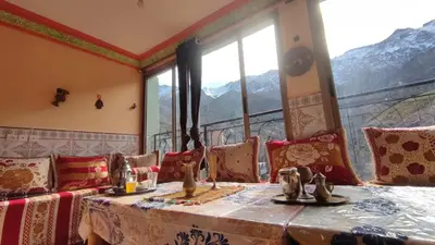 a room with a table and chairs and a window at GITE DETAPE DAR AGSWAL DOUAR WANSKRA OUED IMNANE ASNI MARRAKECh in Tacheddirt