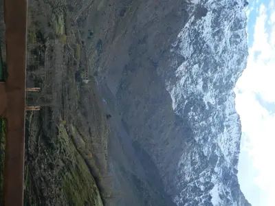 a road on a mountain next to the ocean at GITE DETAPE DAR AGSWAL DOUAR WANSKRA OUED IMNANE ASNI MARRAKECh in Tacheddirt