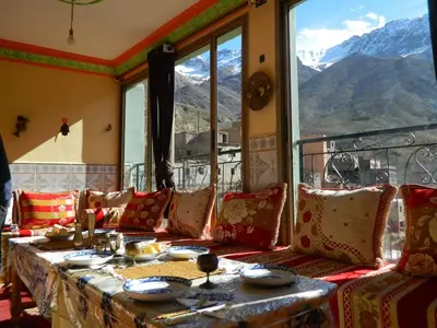 a table in a room with a view of mountains at GITE DETAPE DAR AGSWAL DOUAR WANSKRA OUED IMNANE ASNI MARRAKECh in Tacheddirt