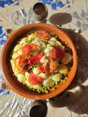 a bowl of food with vegetables on a table at GITE DETAPE DAR AGSWAL DOUAR WANSKRA OUED IMNANE ASNI MARRAKECh in Tacheddirt
