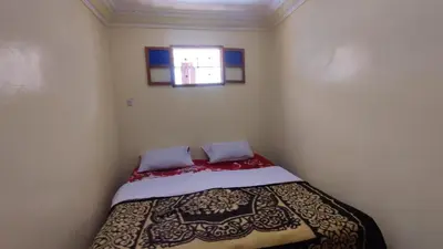 a small bedroom with a bed in a room at GITE DETAPE DAR AGSWAL DOUAR WANSKRA OUED IMNANE ASNI MARRAKECh in Tacheddirt