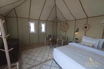 a bedroom with a bed in a tent at Luna Luxury Camp Merzouga in Merzouga