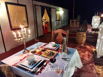 a table with a plate of food on it at Luna Luxury Camp Merzouga in Merzouga