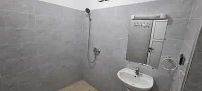 a bathroom with a shower with a sink and a mirror at Appartement neuf centre ville de Tinghir in Tinerhir