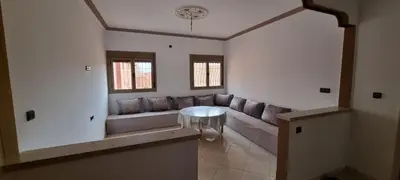 a living room with a couch and a table at Appartement neuf centre ville de Tinghir in Tinerhir
