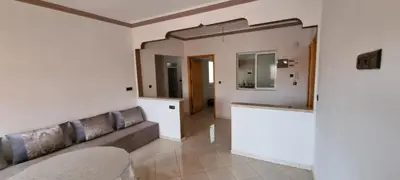a living room with a couch and a mirror at Appartement neuf centre ville de Tinghir in Tinerhir