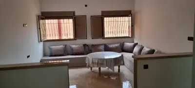 a living room with a couch and a table at Appartement neuf centre ville de Tinghir in Tinerhir