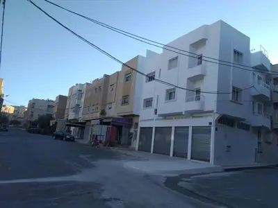 a white building on the side of a street at Al Ambra in Fès
