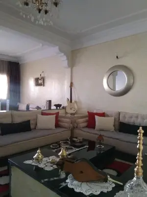 a living room with a couch and a table at Al Ambra in Fès