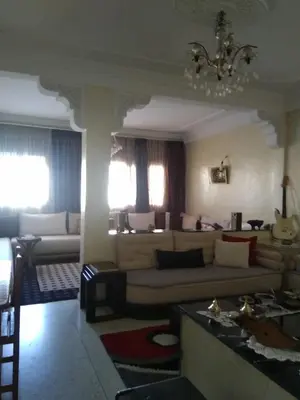 a living room with a couch and a table at Al Ambra in Fès