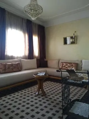 a living room with a couch and a table at Al Ambra in Fès