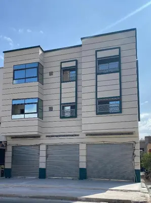 a building with two garage doors and windows at Luxe Escape in Fès