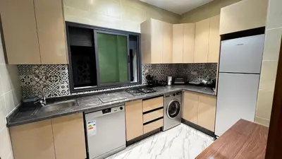 a small kitchen with a sink and a dishwasher at Luxe Escape in Fès