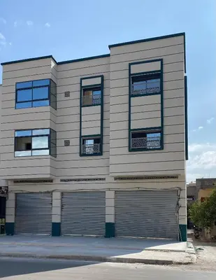 a building with two garage doors and windows at Luxe Escape in Fès