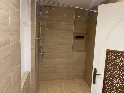 a shower with a glass door in a bathroom at Kasbah Tifirte Grand Vallet in Ourika