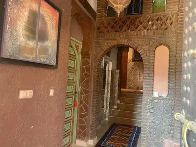 a hallway of a home with a staircase and a painting at Kasbah Tifirte Grand Vallet in Ourika