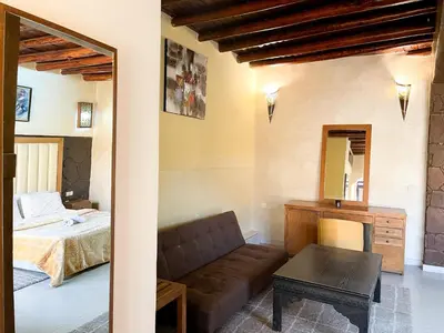a living room with a couch and a bed at Kasbah Tifirte Grand Vallet in Ourika