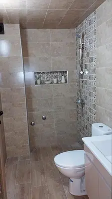 a bathroom with a shower with a toilet and a sink at Appartement meublé in Meknès