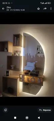 a picture of a bedroom with a bed and a desk at Appartement meublé in Meknès