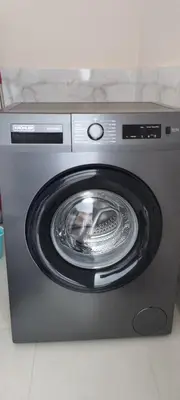 a washing machine with its door open in a room at Appartement meublé in Meknès