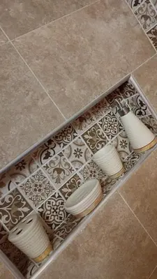 a box filled with white plates on a tile floor at Appartement meublé in Meknès