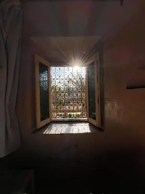 a window in a room with a light shining through it at Heritage House Skoura in Skoura
