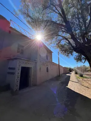 a sun shines on the side of a building at Heritage House Skoura in Skoura