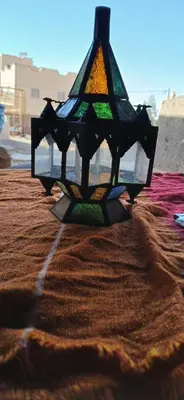 a stained glass window sitting on top of a blanket at Moha House in Merzouga