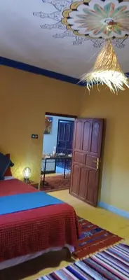 a bedroom with a bed and a ceiling at Moha House in Merzouga