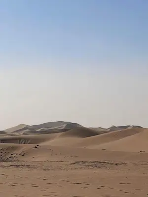 a desert with sand dunes in the distance at Camp Sahara Feeling in El Gouera