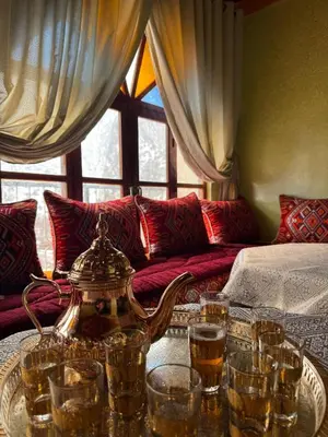 a tea kettle and glasses on a table in a living room at Gite D'etape Ait Ali Nito Assounfou in Megdaz