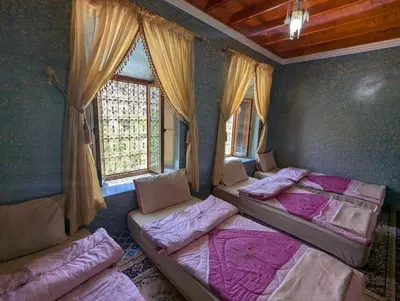 a room with three beds and a window at Gite D'etape Ait Ali Nito Assounfou in Megdaz