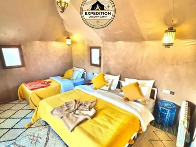 a bedroom with two beds in a room at Expedition Luxury camp in Merzouga