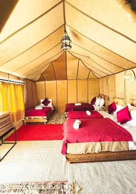 a bedroom with two beds in a tent at Expedition Luxury camp in Merzouga