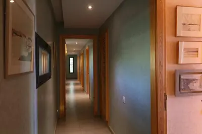 a hallway with many different colored walls and ceilings at Magnifique Villa dans domaine prive in Douar Soukkane