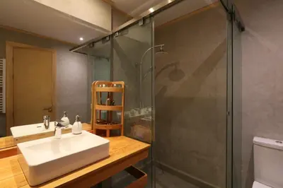 a bathroom with a sink and a glass shower at Magnifique Villa dans domaine prive in Douar Soukkane
