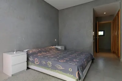 a bedroom with a bed and a dresser in it at Magnifique Villa dans domaine prive in Douar Soukkane