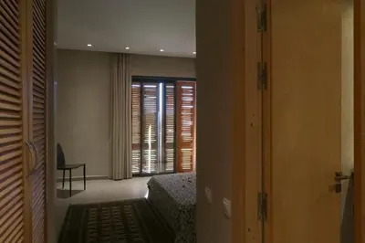 a room with a bedroom with a bed and a window at Magnifique Villa dans domaine prive in Douar Soukkane