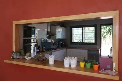 a kitchen with a counter with a large mirror at Magnifique Villa dans domaine prive in Douar Soukkane