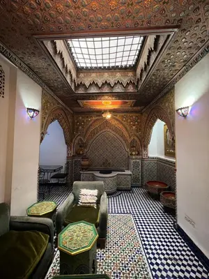 a room with a couch and chairs and a ceiling at Dar Moulin in Fès